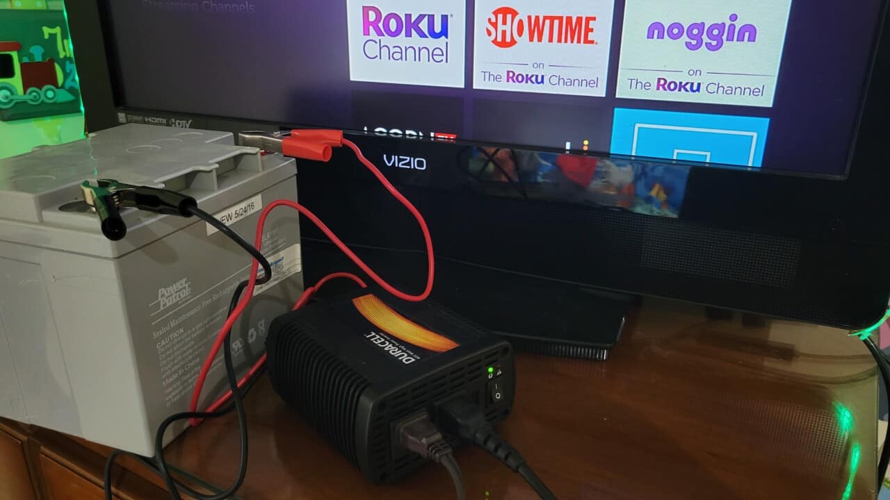 image of a TV and Roku being powered by a 12v battery and an inverter